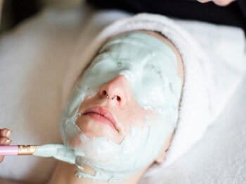 young woman having a facial mask applied at our West Edmonton Spa